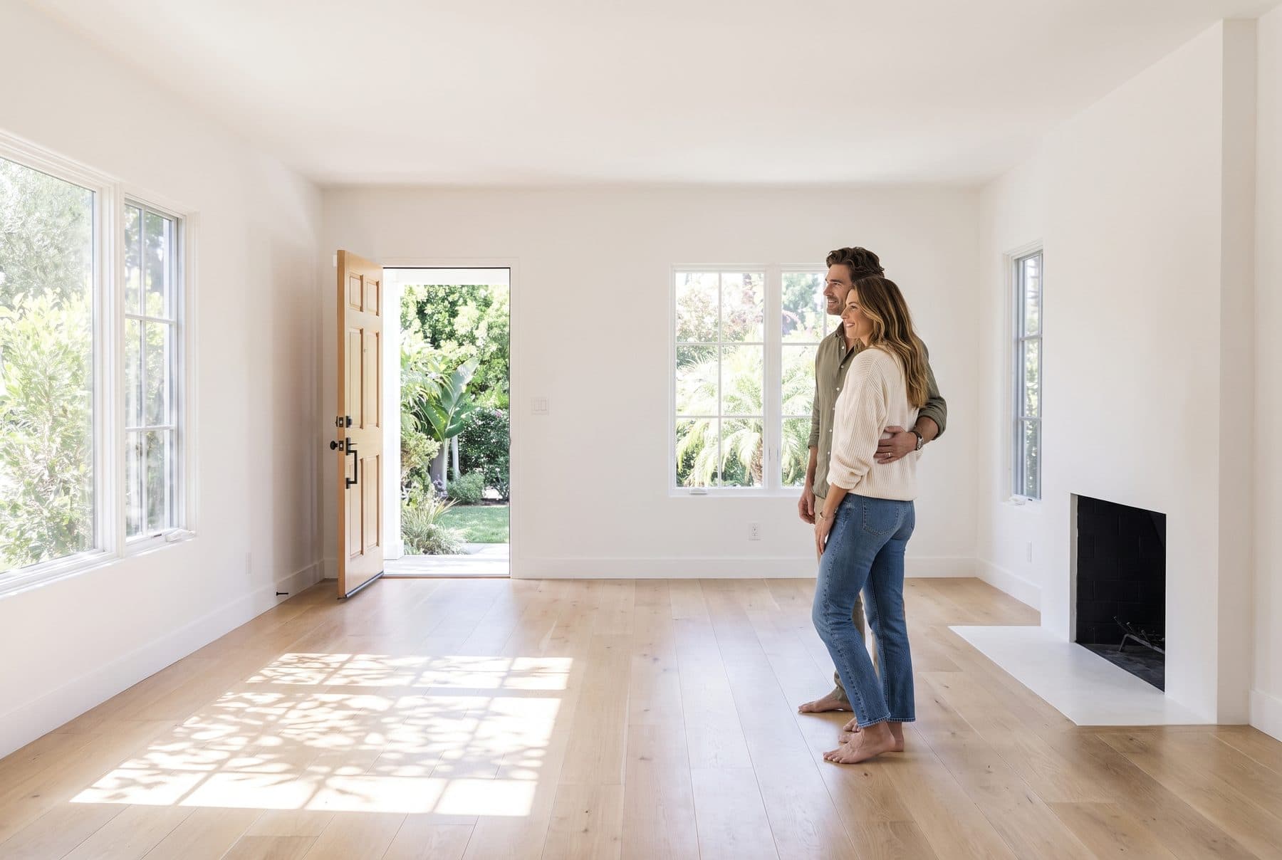 A couple taking one last look around their freshly emptied living room