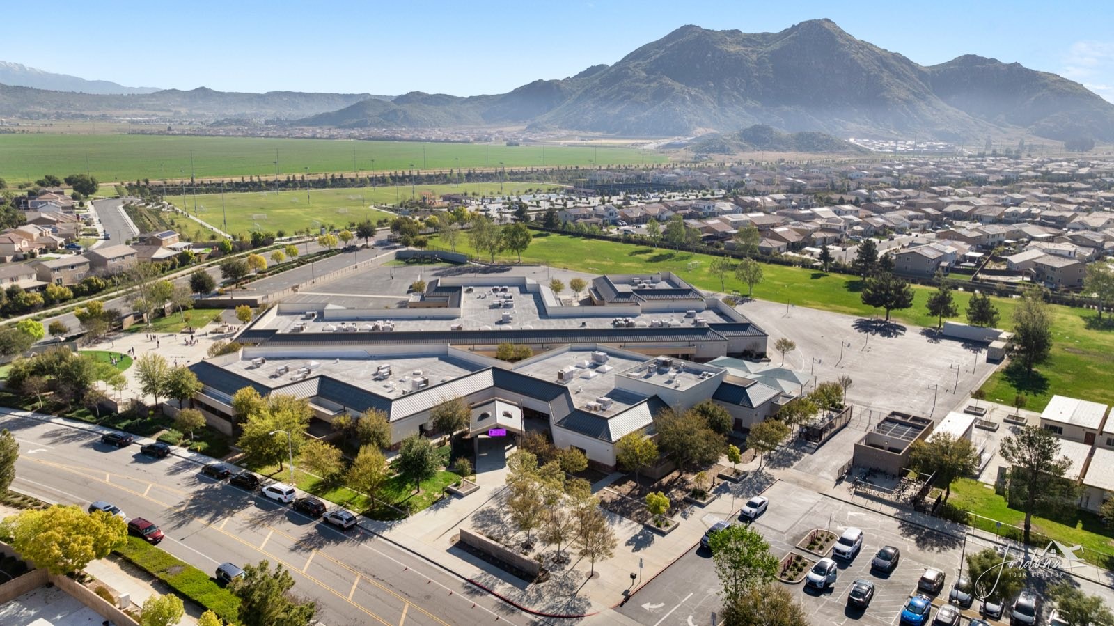 Aerial view of a neighborhood school and its fields near Heritage Lake in Menifee