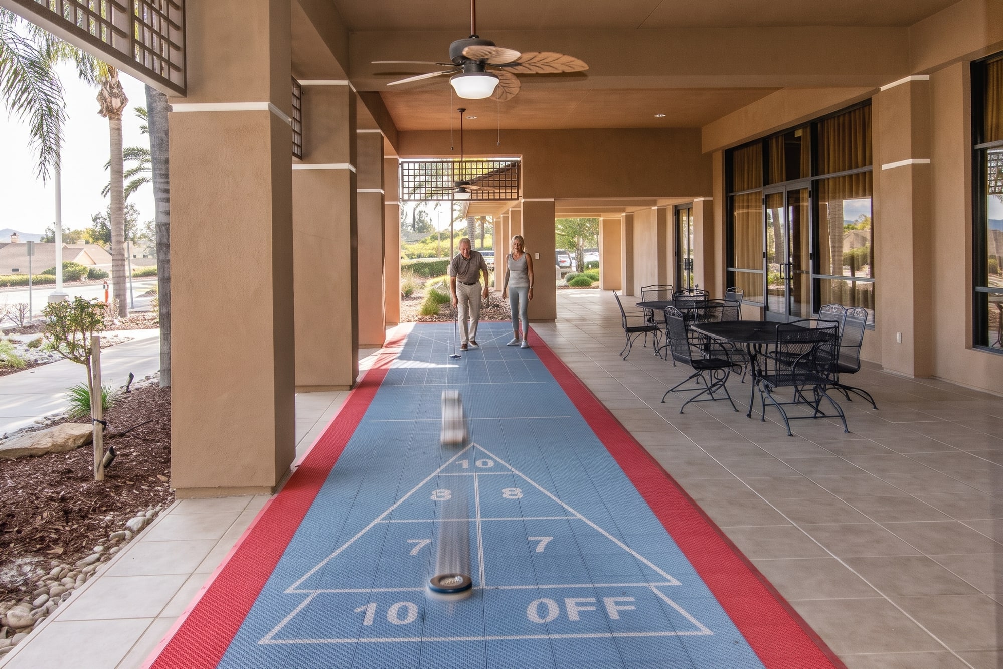 Residents playing shuffleboard on the covered court at The Oasis clubhouse in Menifee