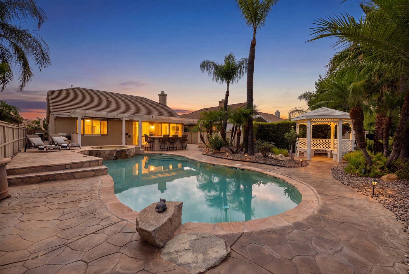 The backyard pool and spa at dusk at 29333 Hidden Lake Dr in The Oasis, Menifee, a home The Hertz Group sold in 2026